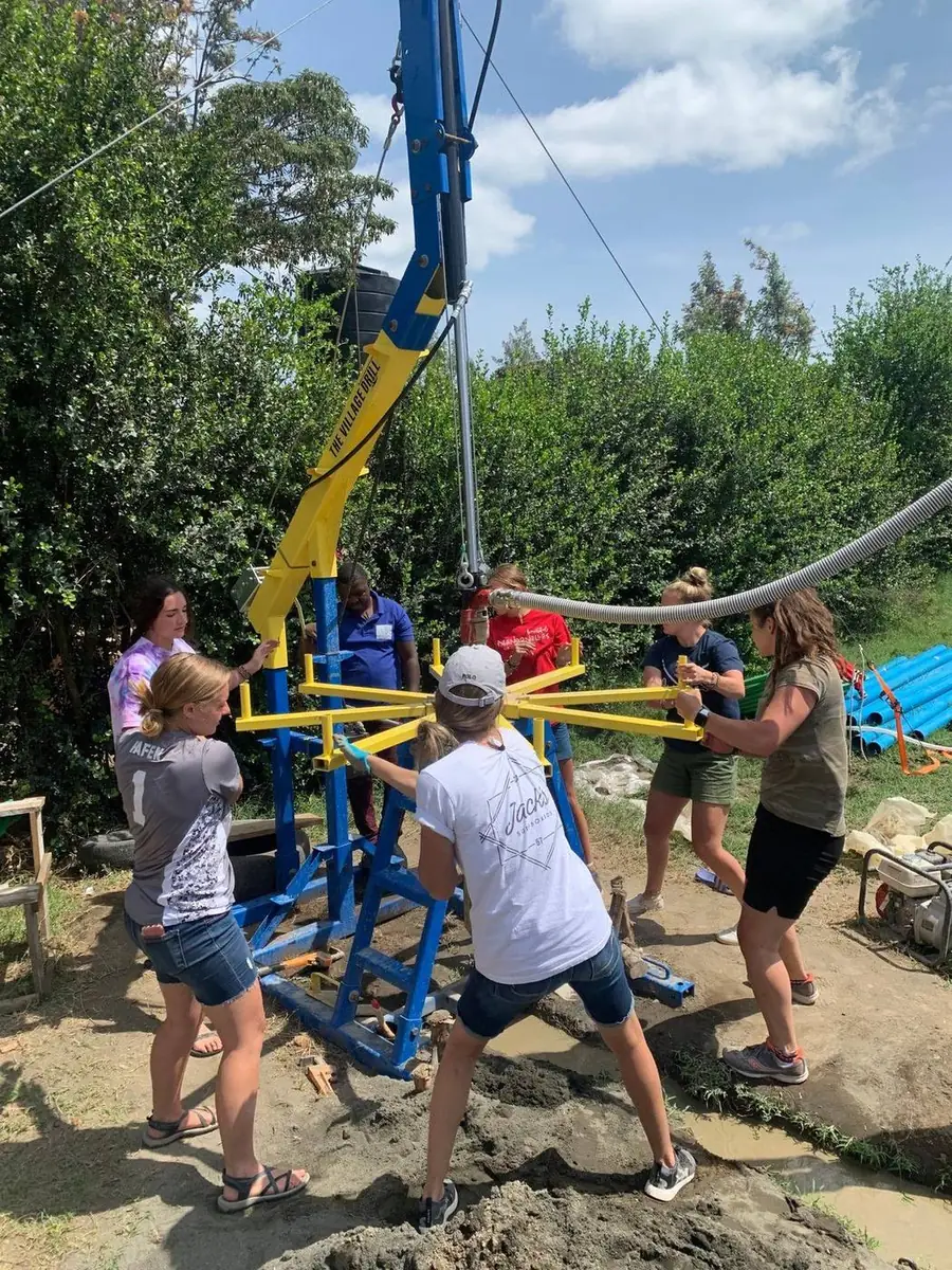 Volunteers and a local crew turn the arms of The Village Drill
